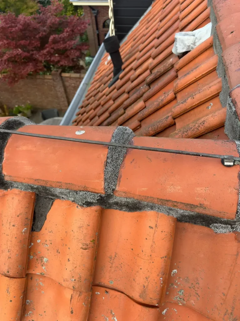 Nokvorsten met een nieuwe mortelvoeg op een rood pannendak in Velserbroek
